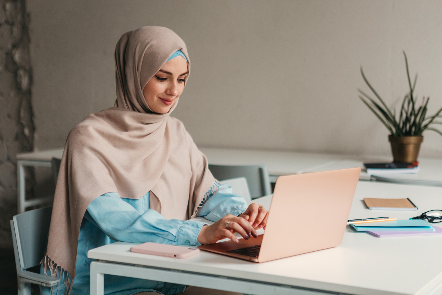 https://alnoor-co.com/wp-content/uploads/2024/01/young-pretty-modern-muslim-woman-hijab-working-laptop-office-room-education-online.jpg